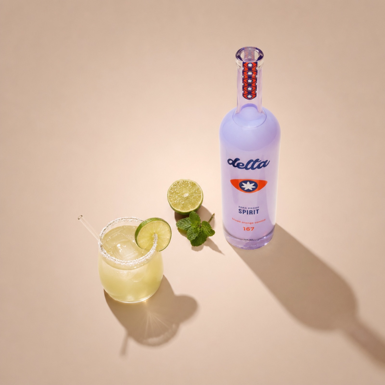 A skinny margarita with salt rim and lime wheel garnish next to the Delta Spirit bottle on a beige background.